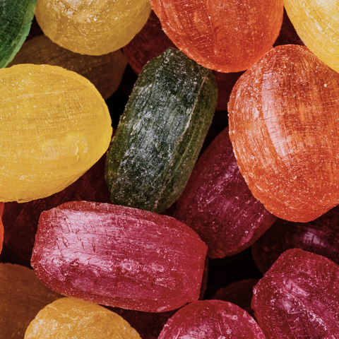 Close-up of brightly colored hard candies in red, orange, yellow and green