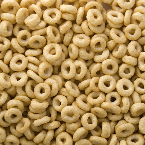 Close-up of plain toasted oat cereal rings filling the frame