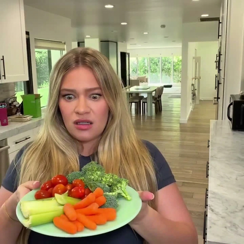 A plate of raw broccoli, carrots and celery