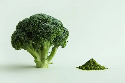 A whole head of broccoli beside a small pile of green powder