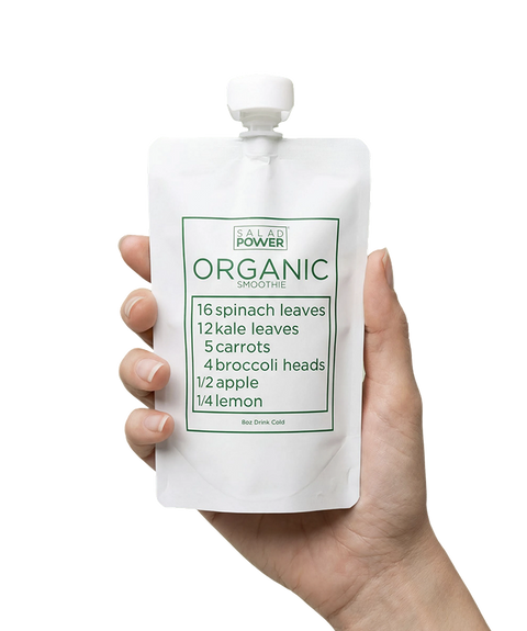 Hand holding a SaladPower organic smoothie pouch